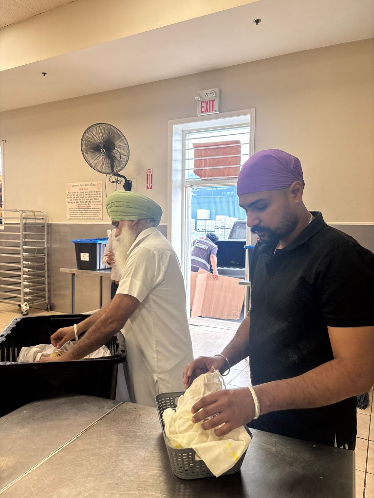 Volunteers preparing and serving food at a community kitchen